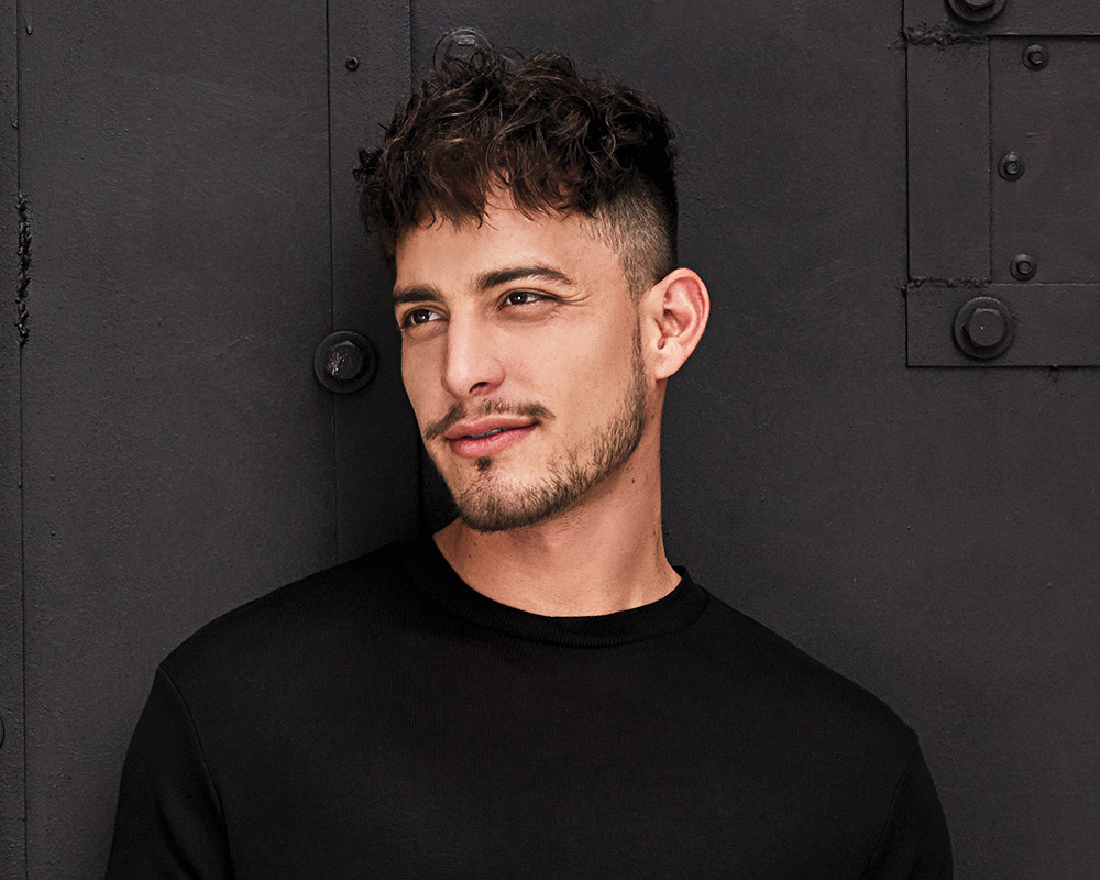 Model wearing Vigor men's hair replacement system by American Hairlines